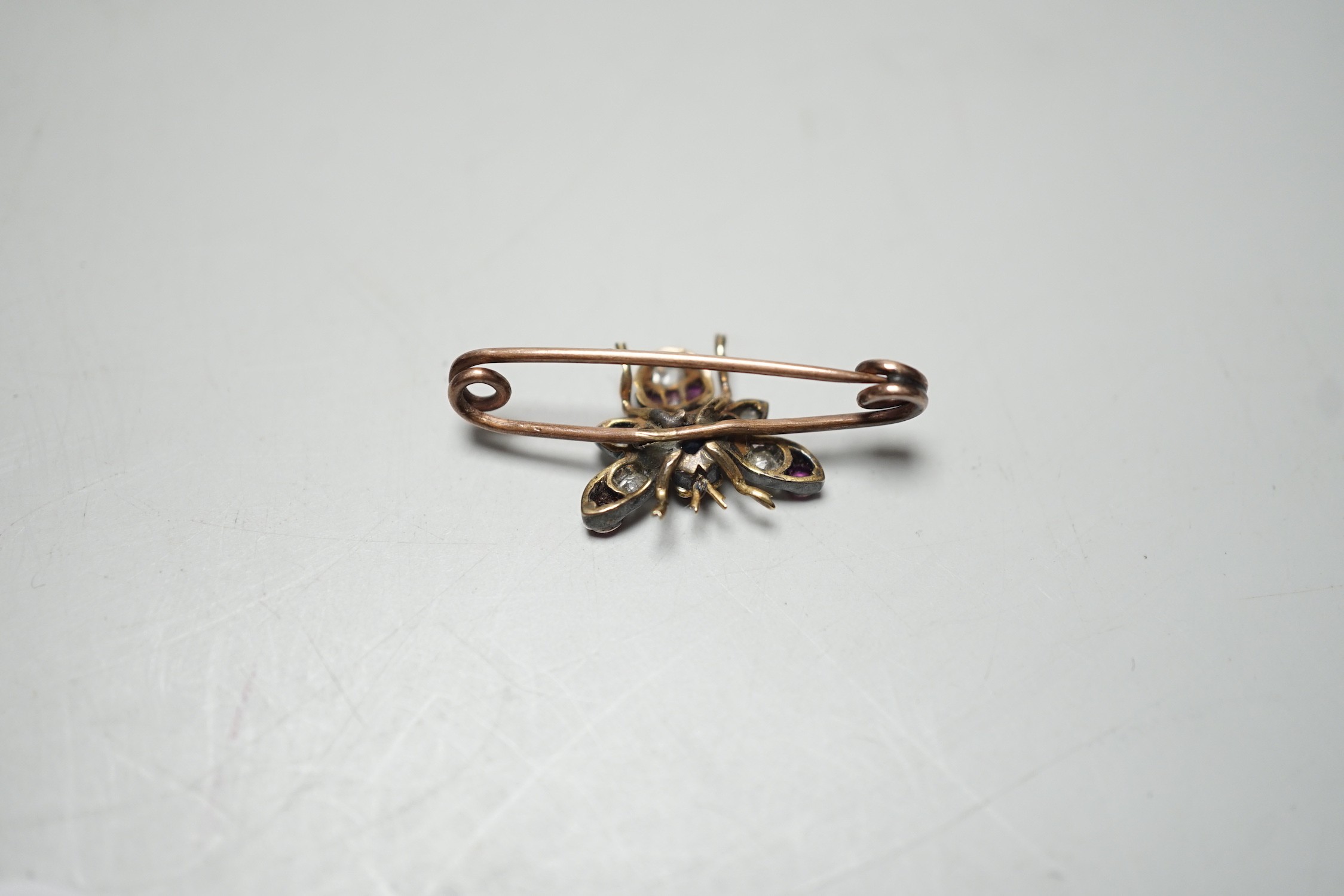 A late Victorian yellow metal, ruby, sapphire and diamond set bug brooch, 30mm, gross weight 2.2 grams.